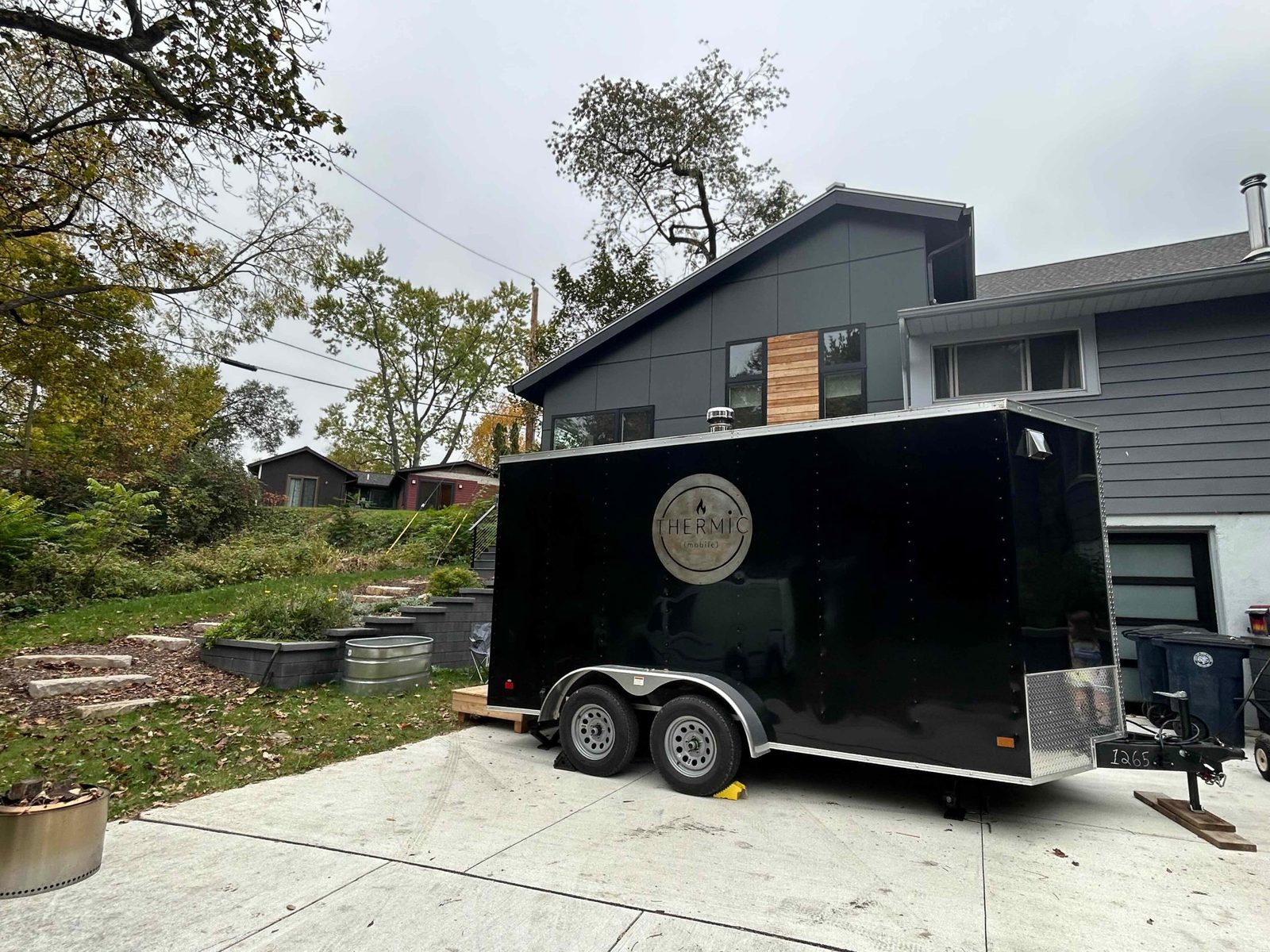 Thermic mobile sauna parked in a residential Ann Arbor driveway on an overcast fall day.
